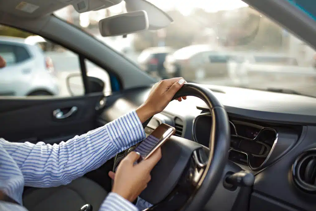 A driver texting while driving.